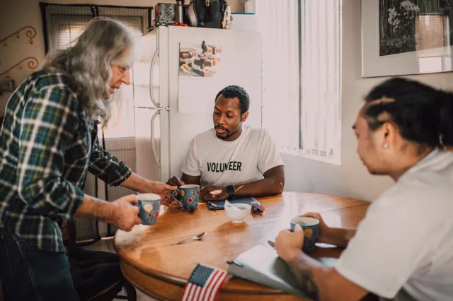 Three volunteers sharing coffee and ideas in a cozy kitchen setting, promoting community engagement. Donor retention: the parts worth your attention