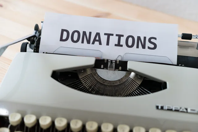 Close-up of a vintage typewriter with a paper displaying the word 'DONATIONS'. Using nonprofit email marketing benchmarks carefully