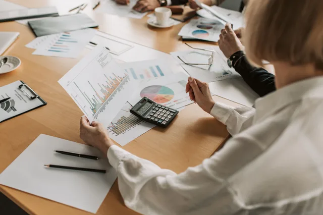Business team analyzing financial data and graphs during a meeting to strategize growth. 4 things nobody tells you about nonprofit fundraising campaigns benchmarks