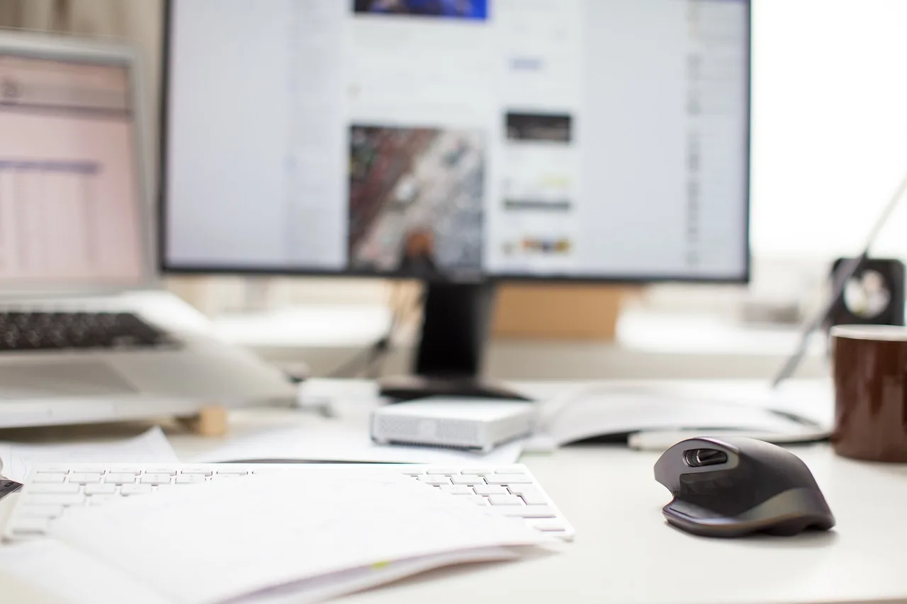 monitor, mouse, keyboard, computer, laptop, macbook, apple, table, white, facebook, internet. Which social media channel should a small nonprofit advertise on first?